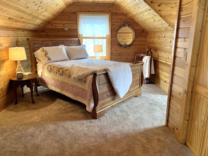 Enjoy the romantic Bee Room in a cozy sleigh bed and a view of the back yard.