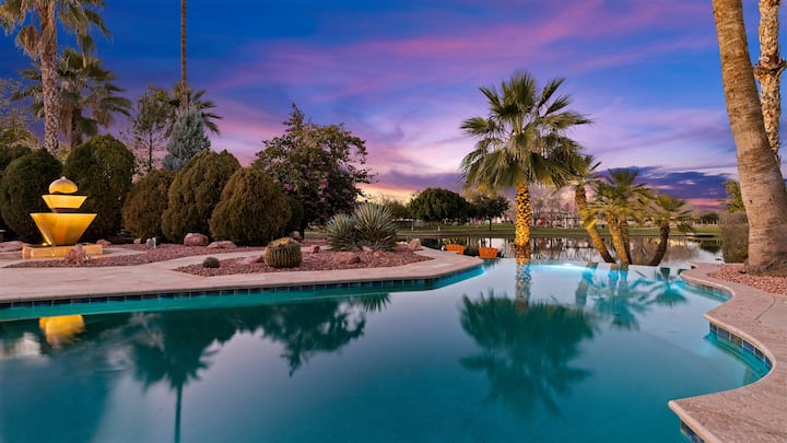 H2O Sanctuary pool with water feature at dusk