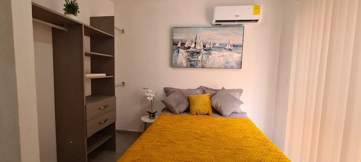 Master bedroom with full closet, air conditioning and workspace: desk and chair, light connections on each side of the bed and desk.