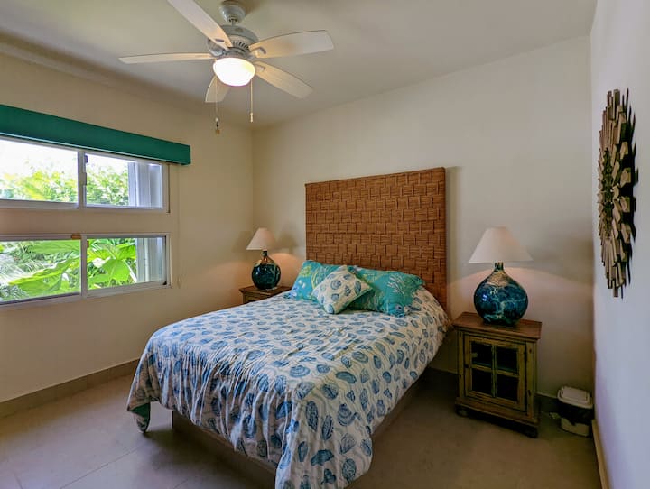 Guest bedroom with queen bed and private connected bathroom.
