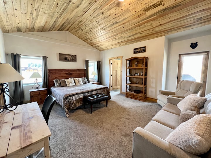 Extra large master suite featuring a luxurious king-size bed, an oh-so-comfy rocking chair recliner, a queen sleeper sofa, and a dedicated works space if you need to check in with the office during your stay. 