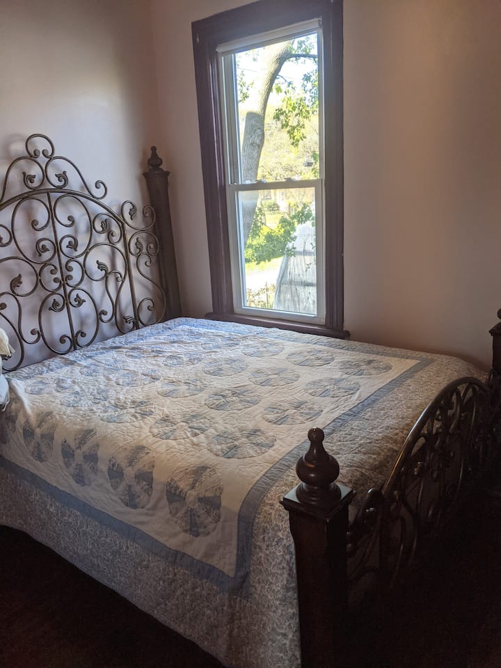 Comfortable Queen sized bed in the master with a view of the garden.