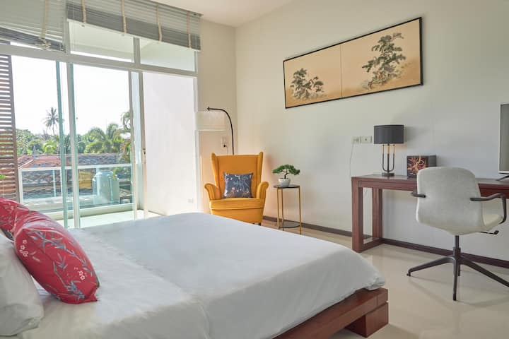 The first room on the upper level with his desk and chill out chair + nice balcony.