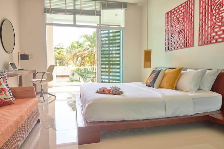 You have the last room with a beautiful Asian decoration, a small sofa, a desk to work and a nice balcony to relax.