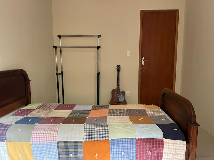 Quarto cama de solteiro com cabideiro e escrivaninha