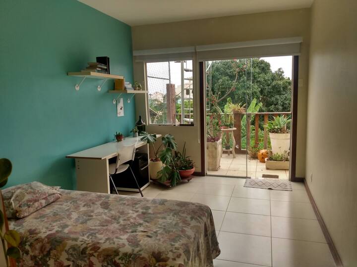 Chumba kilicho na vitanda viwili vya mtu mmoja na roshani ya pamoja na chumba cha kulala kilicho karibu na mlango.