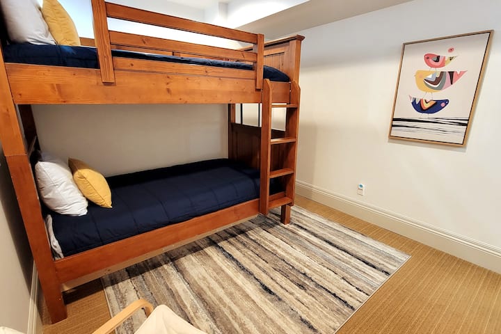 سرير مزدوج ذو طابقين في الطابق السفلي مع سرير مزدوج قابل للسحب في الخزانة.