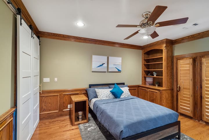 Bedroom four with a comfortable queen bed and a chic sliding barn door entry