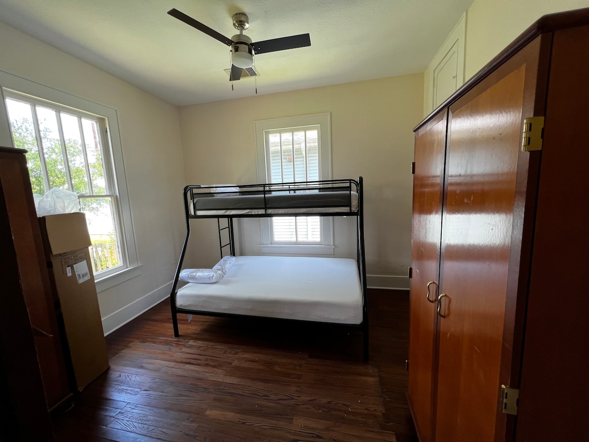 Second bedroom, view back yard view closets, and full size bottom  bed and twin top bunk bed.