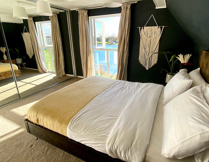 Master Bedroom - Features a Kingsize Barker & Stonehouse Bed with a huge sliding cupboard for luggage and clothing storage and bedside drawers. And the most stunning view of the lake.