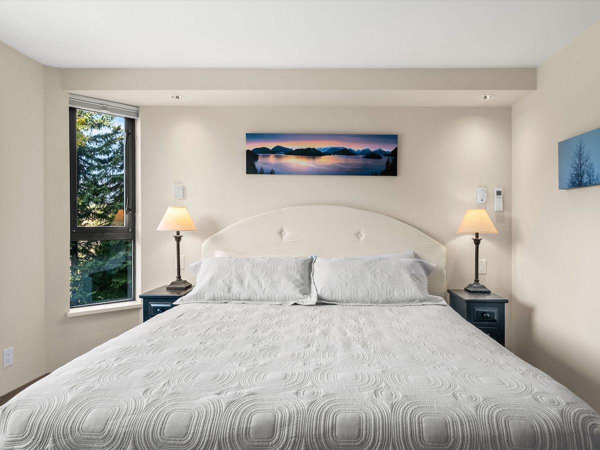 Master bedroom with king bed and nightstands.