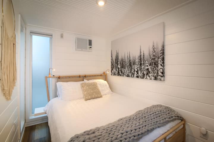 The tiny home has a comfortable queen size bed.