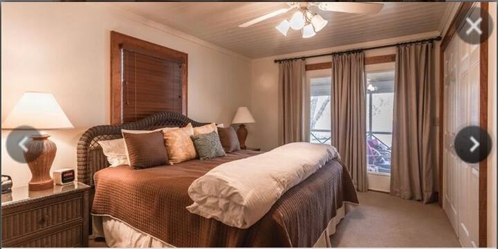 Master Bedroom features walk-out door to porch.  King sized bed and private bathroom. 