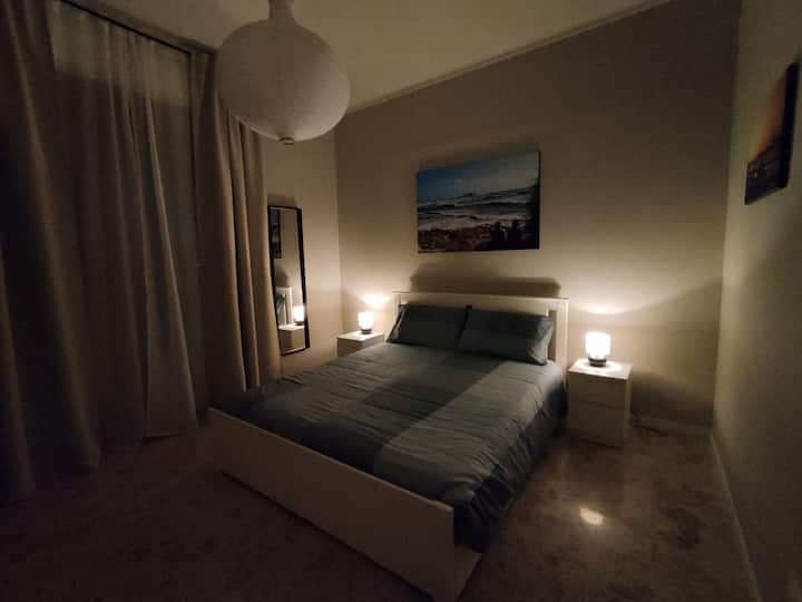 chumba cha kulala kilicho na  kabati la nguo, televisheni mahiri, viango vya nguo, kioo, taa na mapazia ya kuzima