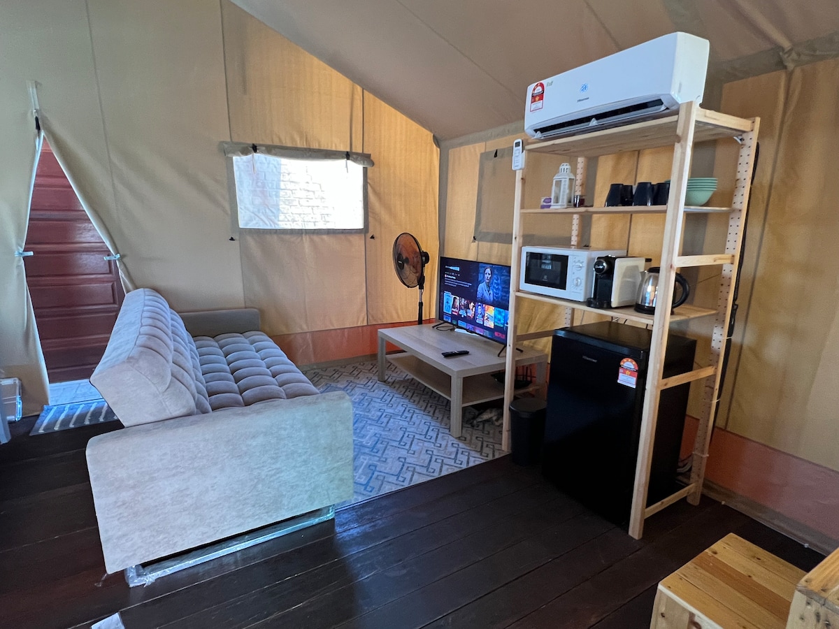 Дневната соба со Android телевизор (Netflix, Youtube и Unifi телевизор), фрижидер, машина за кафе, електричен чајник, пренослив единечен индукциски шпорет и микробранова печка.