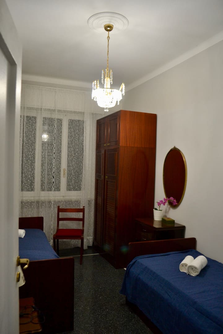 Dormitorio con dos camas individuales y armario con ascensor. 