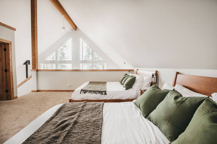 Upstairs is an open loft with two cozy queen size beds and a large wardrobe