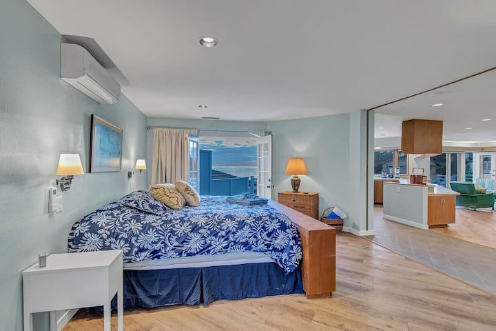 Upper level master suite with balcony, french doors, TV with Roku, beach and ocean view, and king bed.  There is a sliding door you can close for privacy or leave open to the upper living room for a more spacious and open feeling.  