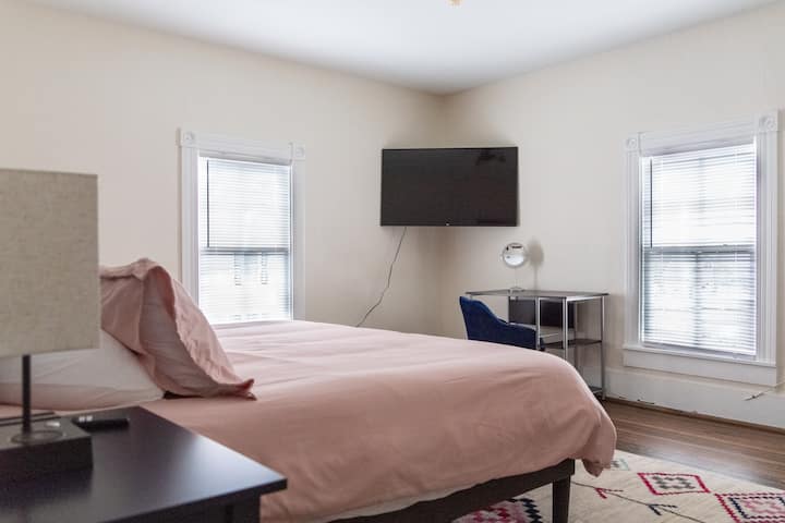 King bed, 4 fluffy pillows, super soft linens, a vanity that can be used as a work space if needed, an antique wash stand for extra storage and a small closet.