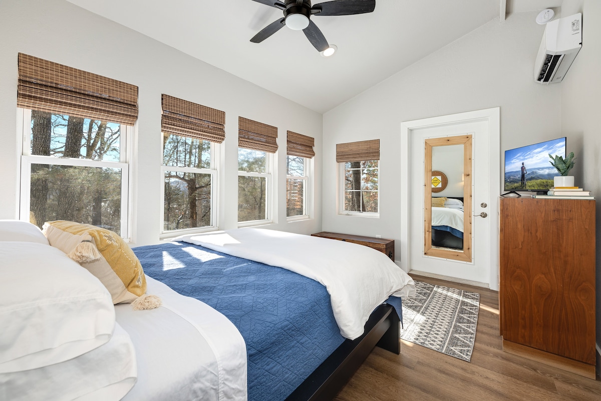 Wake up to forest views  in the spacious bedroom.  