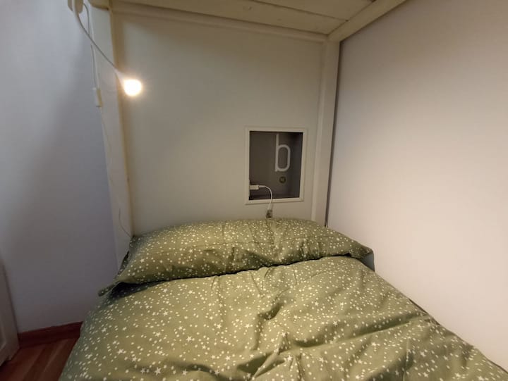 Detalji kreveta na kat s noćnim ormarićem integriranim u uzglavlje. Stolar je prosuo krevet na kat.