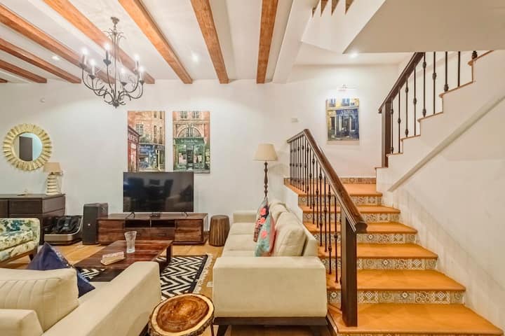 Living Room space with stairs leading to the 1st floor and on.