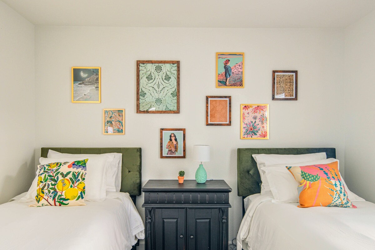 This bedroom has two twin-sized beds: one with a Helix Dawn Luxe mattress  and one with a Alexander Signature Hybrid mattress