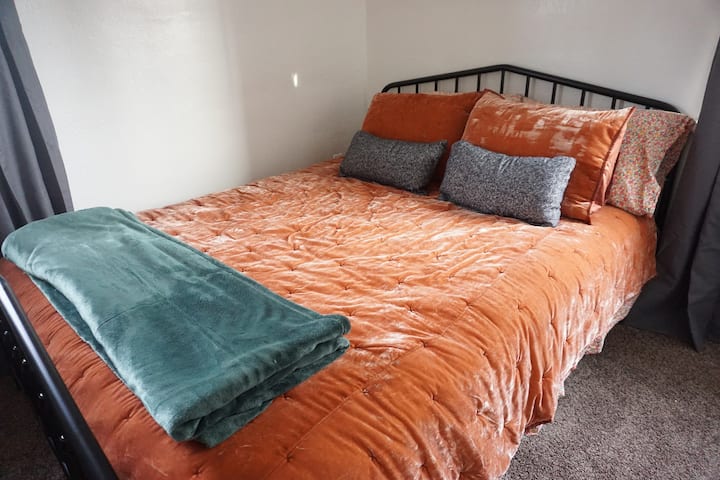 Queen size bed with spare throw blanket
