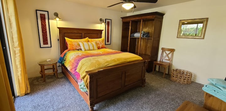 Master bedroom with a high-end mattress, a 55 inch tv, and private bathroom.