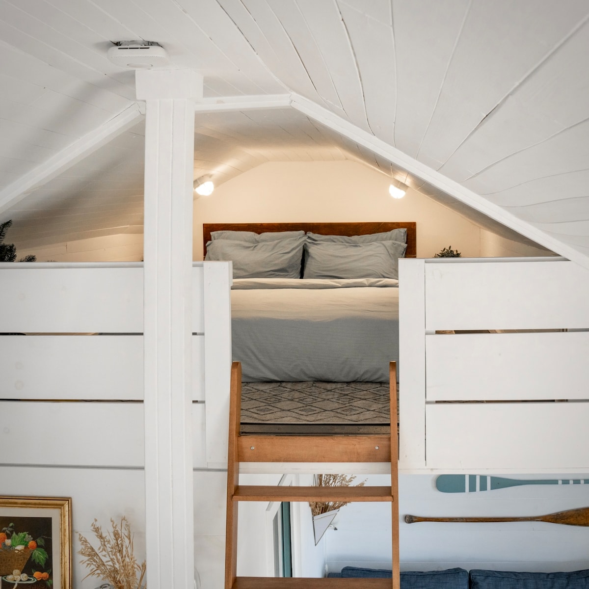 A ladder up to the cozy sleep loft maximizes space & comfort with a second queen bed.