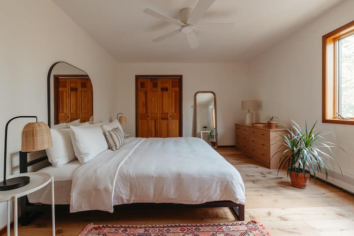 Bedroom 2 - second floor. The largest bedroom, with a King-sized bed, dresser, desk, and Herman Miller desk chair.