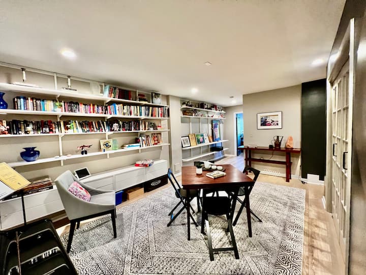 Downstairs game room with books, card table and piano