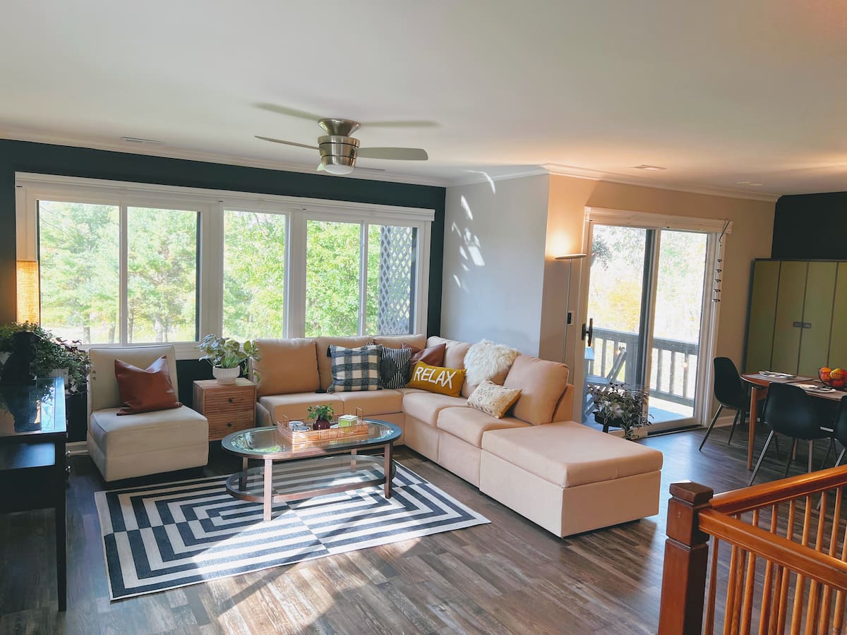 Living room at Hillside Heaven with windows onto the deck