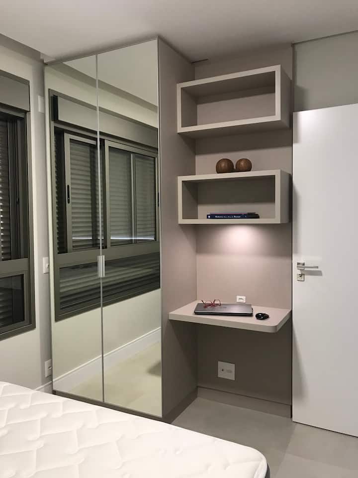 Suite 2 - Side view | Electric Persian | White Curtain Rolo | Planned Furniture | Guard Clothes | Mirror | Workbench | Indirect LED lighting. 