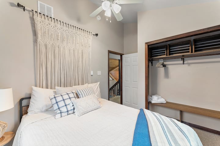 Welcome to our beautiful second-floor boho-themed room, where relaxation and style meet stunning views of the hot tub and fire pit below. With a comfortable queen-sized bed and a large closet, you'll have all the space you need to make yourself at h