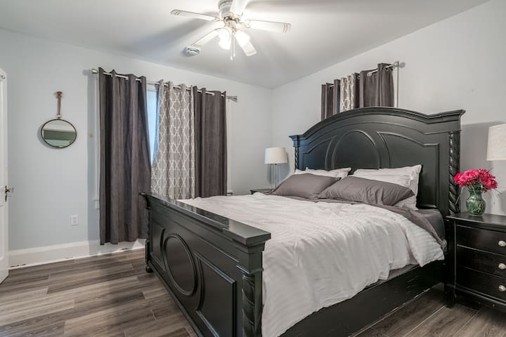 The Master bedroom features a king size bed, private ensuite full bathroom, and black out curtains. 
