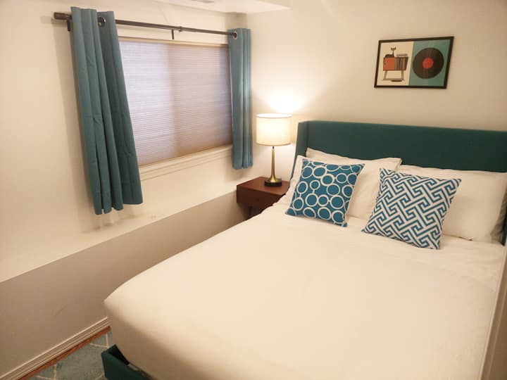 The fourth bedroom on the bottom floor is designed in retro teal.