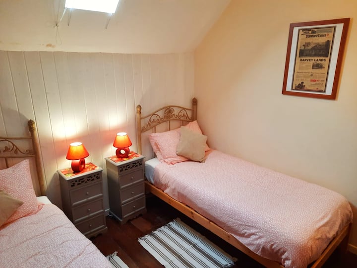 This twin room offers two single beds which can be joined to make one double on request, creating three double beds in the property. It also has plenty of storage with a wardrobe and a set of draws.