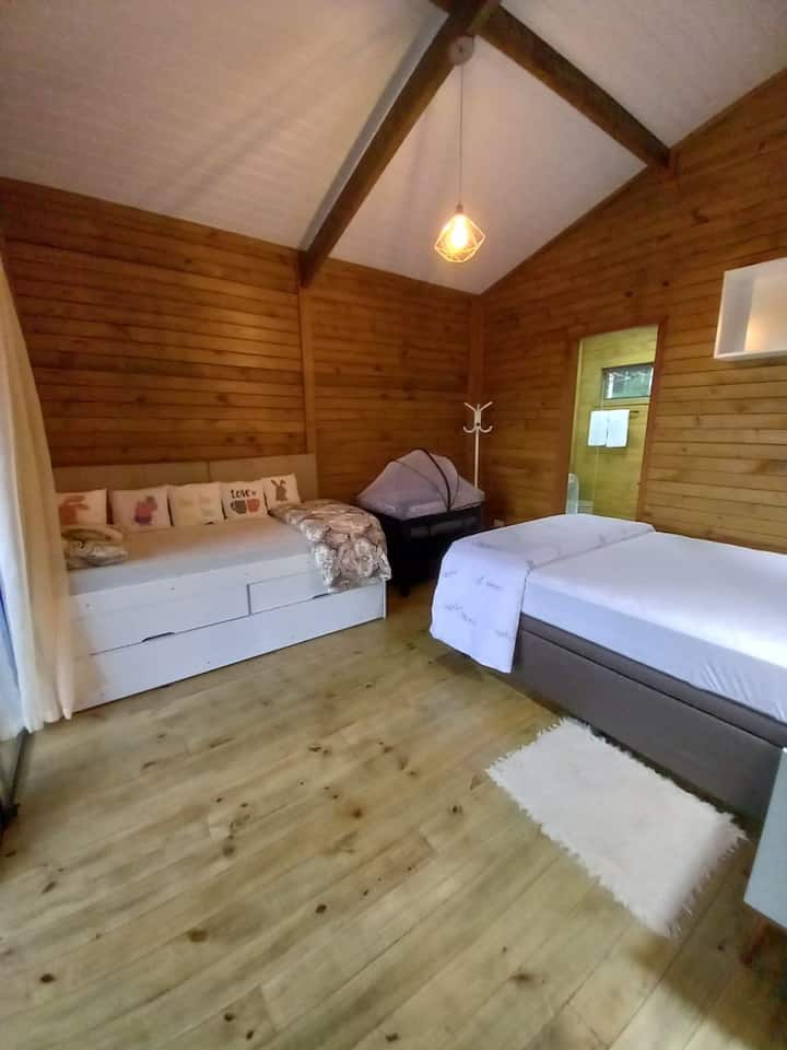 A double bed, portable crib (on demand) and a bunk bed