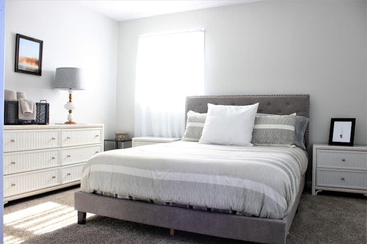 2nd bedroom with queen size bed, seating area and nice size closet, two night stands, dresser and mirror.