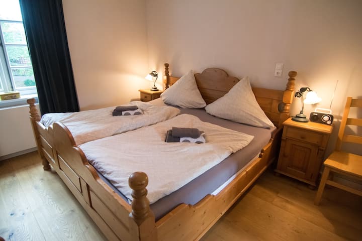 A bedroom with a double bed