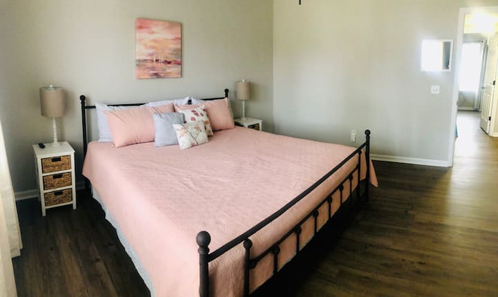 Master bedroom, located upstairs. Sleep comfortably on a hybrid king mattress (gel-infused pressure-relieving memory foam and pocketed coils for support)! 