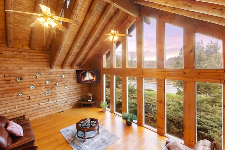 Cozy Spacious Living room showcases exposed log beams with Panoramic Windows
70" Smart TV with Game Consoles.