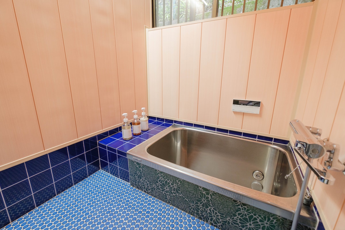 かわいらしいタイルが特徴的なバスルーム。リフォーム済みの水まわりはシンプルで清潔です。オーガニックのボディソープ・シャンプー・コンディショナーを用意しています。