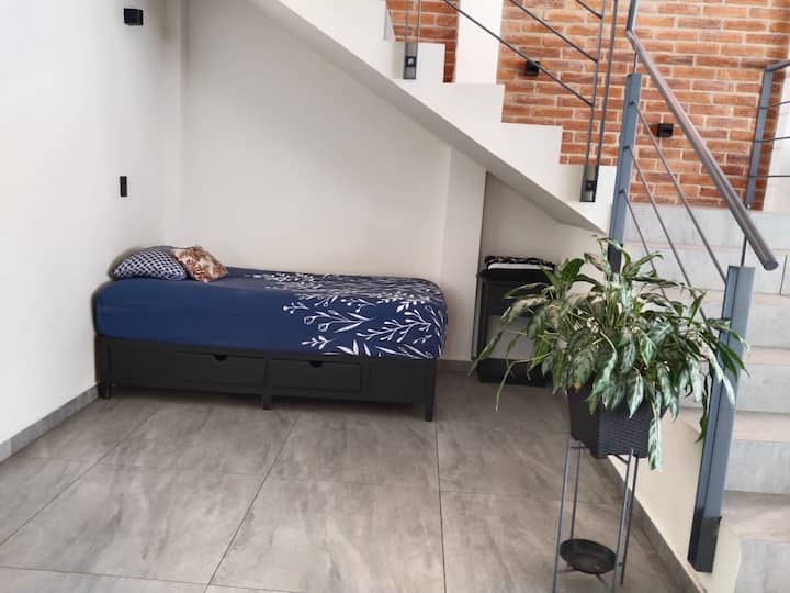 Comfortable single bed under the stears