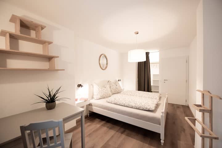 Double bed room with desk and walk-in closet in the Moar Mill in Völs