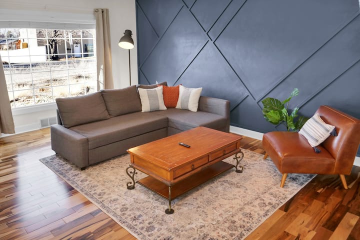 Mid-century modern design living room with geometric accent wall 