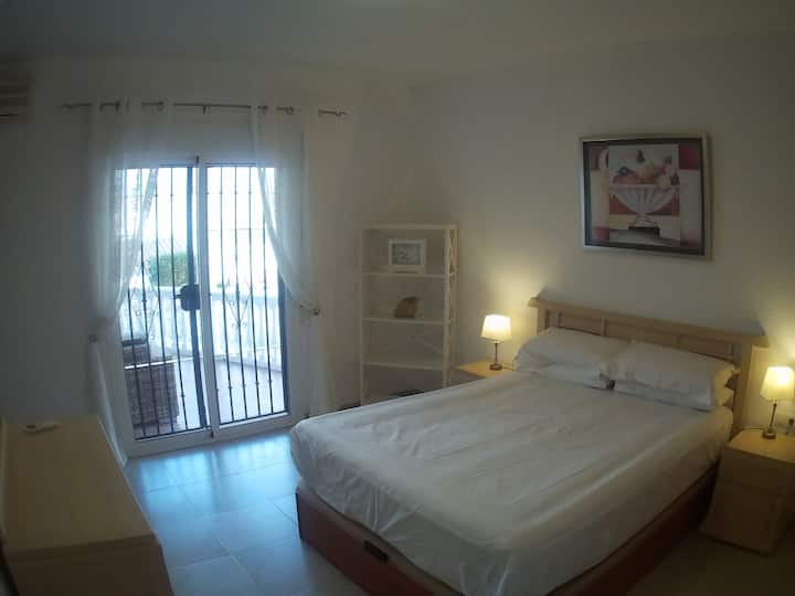 Master bedroom with excellent bed ,  air conditioning, ensuite bathroom and with sliding doors access to veranda and swimming pool