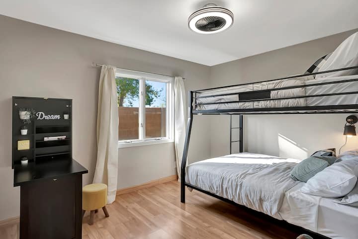Enjoy the practicality of our fourth bedroom, featuring bunk beds (Full over Queen) and a convertible desk for a comfortable and versatile stay