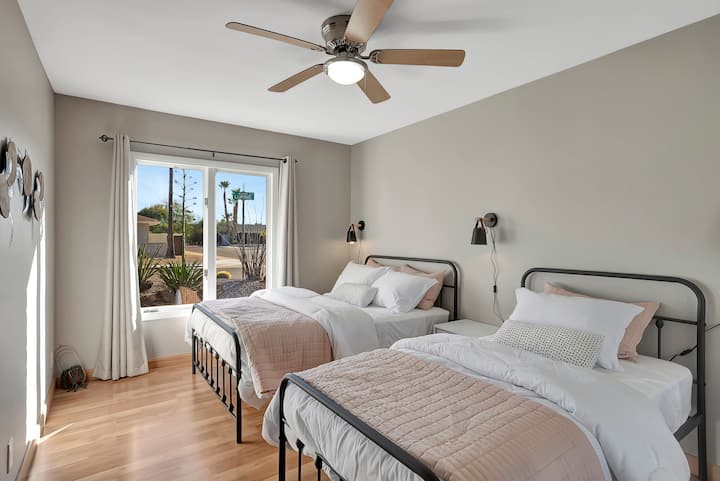 Experience the beauty of the ocean in our bedroom, featuring two beds and beach-inspired decor for a comfortable and stylish coastal retreat